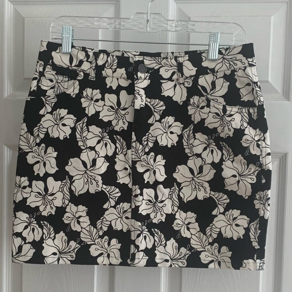 Motel | NWT denim style mini skirt with white florals; front zipper and pockets